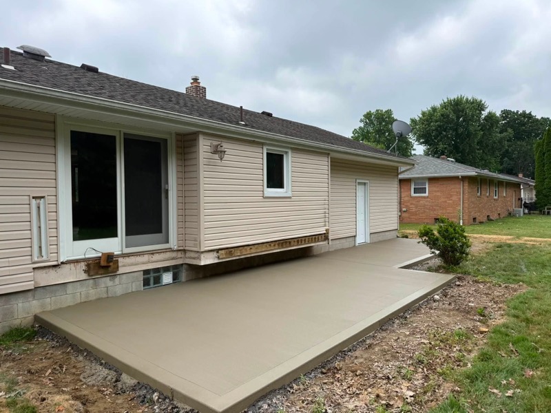 Smooth finish backyard patio with sliding door access