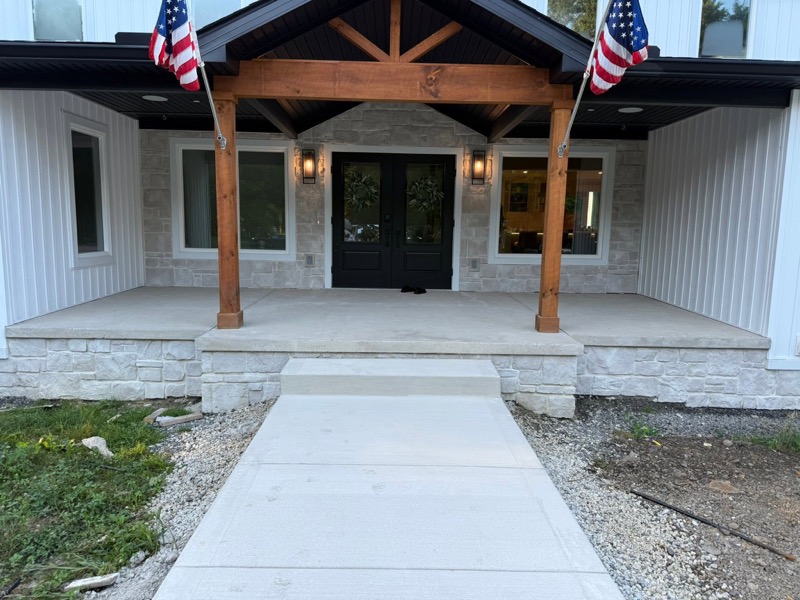 Concrete front entry walkway and porch with stone veneer